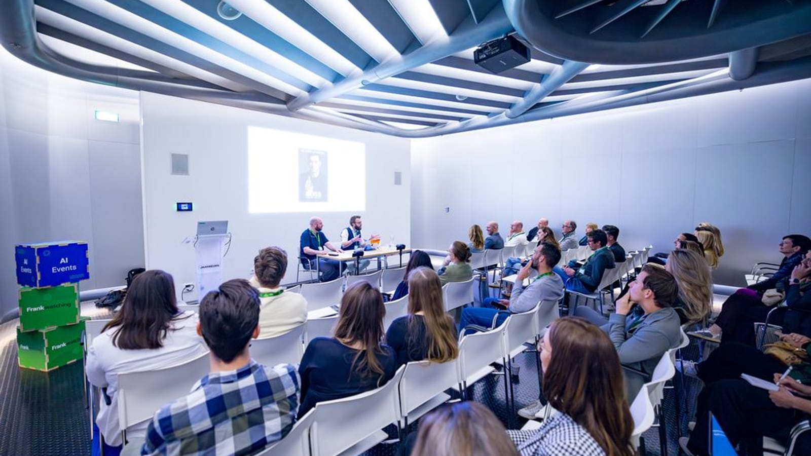 Deelnemers met laptops en aantekeningen tijdens een sessie